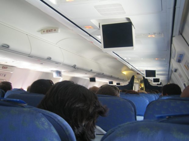 Coach - inside an airplane Coach - inside an airplane